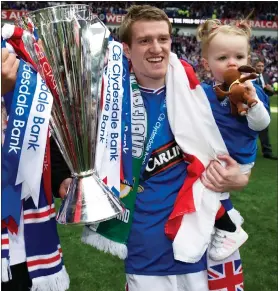  ??  ?? Steven Davis lifts the SPL trophy during his first stint at Rangers in 2010