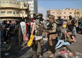  ?? KHALID MOHAMMED — THE ASSOCIATED PRESS ?? Anti-government protesters gather on Rasheed Street in Baghdad, Iraq, Wednesday. Several protesters were killed by security forces who fired live rounds in Baghdad and southern Iraq amid ongoing violence and days of sit-ins and road closures, Iraqi officials said Wednesday.