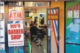  ??  ?? LOCAL BUSINESSES such as MC’s Barber Shop are being joined by new developmen­ts popping up on Western Avenue.