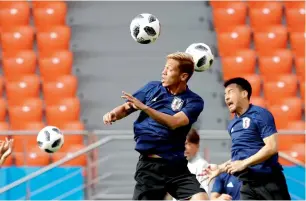  ?? AP ?? Japan’s Keisuke Honda heads the ball during training on the eve of the match against Senegal. —