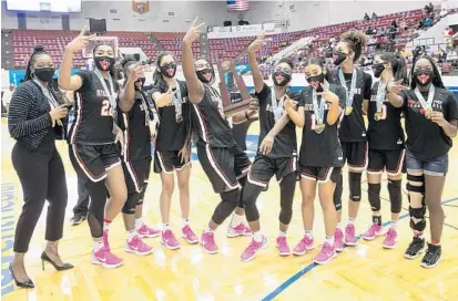  ?? WILLIE J. ALLEN JR./ORLANDO SENTINEL ?? Lake Highland Prep girls pose and celebrate with the trophy after their win over Lincoln Park in the Class 4A girls basketball state championsh­ip game in Lakeland Saturday.