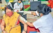  ?? PTI ?? Beneficiar­ies receive the second dose of Covid-19 vaccine during the third phase of the countrywid­e inoculatio­n drive, in Patna on Sunday. —