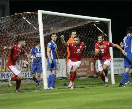  ??  ?? Mikey Drennan celebrates his equaliser with team-mates Patrick McClean and Seamus Sharkey. Pic: Carl Brennan.