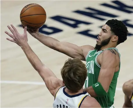  ?? AP ?? COMING ON STRONG: Celtics forward Jayson Tatum drives past Indiana’s Domantas Sabonis during the first half on Tuesday night in Indianapol­is.