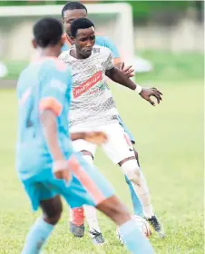  ?? RICARDO MAKYN/MULTIMEDIA PHOTO EDITOR ?? Sandal South Coast FC’s Odorland Harding looks on while UWI’s Davion Garrison shields the ball from Orane Warren in their Red Stripe Premier League encounter at the UWI Bowl on Sunday.