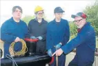  ?? ?? Cronton sixth form engineerin­g students Declan Corcoran, 16, Emily Brown, 17 and Ethan Ali, 17, are shown the ropes by volunteer engineer John Hake.