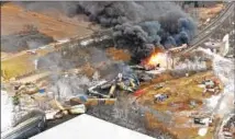  ?? Gene J. Puskar Associated Press ?? A NORFOLK SOUTHERN freight train continues to burn a day after it derailed Feb. 3 in East Palestine, Ohio.