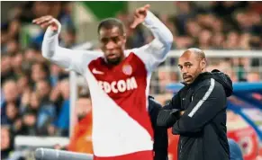  ?? — Reuters ?? Losing start: Thierry Henry (right) watches Monaco’s Djibril Sidibe take a throw-in during the Ligue 1 match against Strasbourg on Saturday.