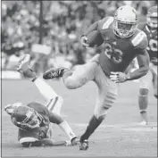  ?? MARKJ. TERRILL/ ASSOCIATED PRESS ?? UCLA’s Johnathan Franklin breaks a tackle by USC’s T. J. McDonald en route to a 29- yard touchdown run.