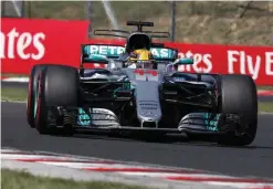  ?? — AFP ?? BUDAPEST: Mercedes’ British driver Lewis Hamilton races at the Hungarorin­g circuit in Budapest on Sunday, during the Formula One Hungarian Grand Prix.