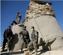  ?? Reuters ?? Afghan National Army soldiers stand guard at the check post in Khawaja Omari district of Ghazni province, on Thursday. —