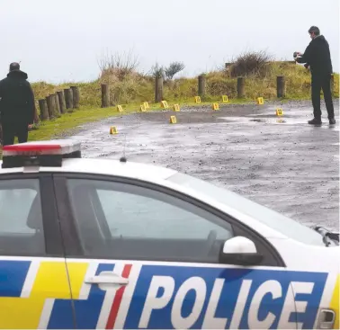  ?? ALAN GIBSON / NEW ZEALAND HERALD / THE CANADIAN PRESS / AP ?? Police collect and photograph evidence in the parking lot of the Te Toto Gorge lookout on Whaanga Road, south of Raglan, New Zealand, on Friday. A manhunt was underway after an Australian tourist was killed following what police believe was a random attack. A suspect was arrested Saturday and faces several charges including murder.
Police say a Canadian woman is ‘shocked and distressed’ after her Australian fiancé was killed.