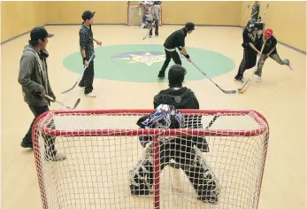  ?? JON THOMPSON ?? Students play floor hockey in Pikangikum­ís new gymnasium in 2011. It was converted to a courtroom the next day. Research shows that youth report an increase in resilience when they are brought together for cultural activities.