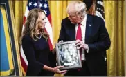  ?? JABIN BOTSFORD / WASHINGTON POST ?? President Donald Trump presents Valerie Nessel, widow of Air Force Tech Sgt. John Chapman, with her husband’s Medal of Honor during a ceremony at the White House on Wednesday.