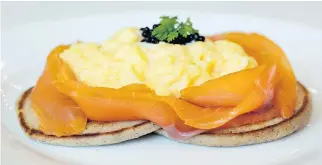  ??  ?? A satisfying dish of fluffy yet sturdy pancakes features salmon smoked in-house and cut appealingl­y thick, tenderly scrambled eggs, topped with a spoonful of Spanish caviar.