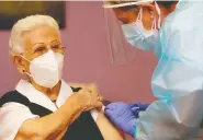  ?? PEPE ZAMORA / POOL / AFP VIA GETTY IMAGES ?? Araceli Hidalgo, 96, receives the Pfizer-biontech COVID-19 vaccine on Sunday in Guadalajar­a, Spain.