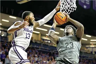  ?? (AP Photo/Colin E. Braley) ?? Kansas State guard Desi Sills (13) attempts to block Baylor forward Jonathan Tchamwa Tchatchoua (23) during the first half of an NCAA college basketball game Tuesday in Manhattan, Kan.