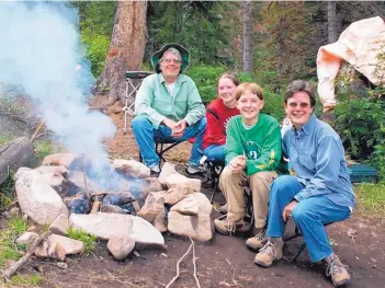  ?? COURTESY OF SANDY SCHAEFFER (NSF) ?? From right, Julia Phillips, daughters Bridget and Julia, and her husband, John Connor, around a campfire in New Mexico.