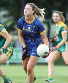  ??  ?? Wicklow’s Niamh McGettigan looks to offload a pass during the Leinster Intermedia­te football championsh­ip clash with Meath in Roundwood on Sunday.