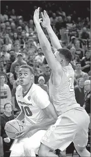  ?? NWA Democrat-Gazette/CHARLIE KAIJO ?? Arkansas forward Daniel Gafford looks to take a shot against Tennessee forward Grant Williams during the Razorbacks’ victory Saturday in Fayettevil­le. Gafford finished with 15 points and gamehighs of 8 rebounds and 5 blocked shots in 33 minutes.