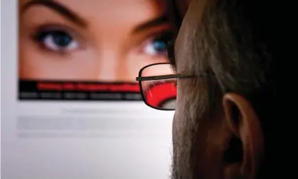  ?? Photograph: Eva Hambach/AFP/Getty Images ?? A man looking at an attractive woman on an internet dating site.
