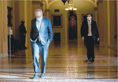  ?? STEFANI REYNOLDS/THE NEWYORKTIM­ES ?? Senate Minority Leader Chuck Schumer (D-N.Y.) wears a face mask at the Capitol in Washington on Saturday. Pennsylvan­ia Republican Sen. Pat Toomey and Schumer met to exchange ideas on the COVID-19 economic relief plan.