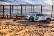  ?? ROBERTO E. ROSALES/JOURNAL ?? A Border Patrol agent drags tires along the border wall on Wednesday near Santa Teresa to flatten the dirt and make any migrant footprints stand out.