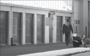  ?? JOHN WOODS, THE CANADIAN PRESS FILE PHOTO ?? Company security staff walk past storage lockers in Winnipeg in 2014. A court found that Andrea Giesbrecht concealed bodies of her dead babies in a storage locker.