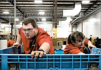  ?? CALLA KESSLER/FOR THE WASHINGTON POST ?? Colton Channon, left, was hired by Dee Zee Manufactur­ing, an Iowa firm that makes truck and SUV accessorie­s.