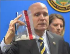  ?? PETE BANNAN-MEDIANEWS GROUP ?? Chester County District Attorney Tom Hogan holds a bag of crystal meth taken in the arrest of a mid-level dealer. Hogan held a press conference Wednesday on methamphet­amine traffickin­g in the county.