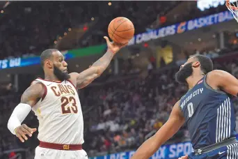  ??  ?? Cleveland Cavaliers forward LeBron James rebounds beside Detroit Pistons center Andre Drummond in the second quarter of their NBA match at Quicken Loans Arena in Cleveland, Ohio, on Monday. The Cavaliers won 112-90. — Reuters