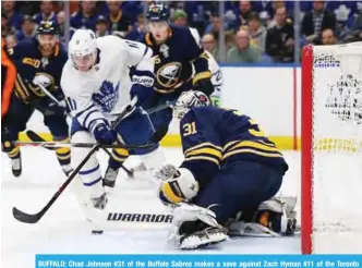  ?? — AFP ?? BUFFALO: Chad Johnson #31 of the Buffalo Sabres makes a save against Zach Hyman #11 of the Toronto Maple Leafs during the third period at KeyBank Center on Monday in Buffalo, New York.