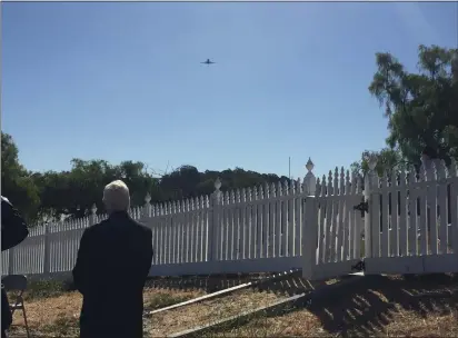  ?? PHOTOS BY THOMAS GASE — TIMES-HERALD ?? Vallejo Mayor Robert McConnell, who is also a veteran, watches a flyover by Captain Joseph Phillips of the U.S. Air Force over the Mare Island Naval Cemetery during a Memorial Day event on Monday morning.