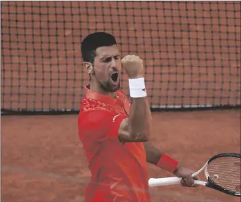  ?? JEAN-FRANCOIS BADIAS/AP ?? SERBIA’S NOVAK DJOKOVIC celebrates winning his quarterfin­al match of the French Open tennis tournament against Russia’s Karen Khachanov in four sets, 4-6, 7-6 (7-0), 6-2, 6-4, at the Roland Garros stadium in Paris on Tuesday.