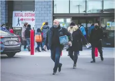  ?? ASHLEY FRASER ?? Costco shoppers leave the Gloucester location on Saturday. Some people have voiced concerns about crowds at large retailers.