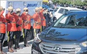  ?? JOE GIBBONS/THE TELEGRAM ?? RCMP police officers salute as the remains of their comrade RCMP Cpl. Trevor O’keefe were being carried to the cemetery in Tors Cove following the regimental funeral service for Cpl. O’keefe at the Sts. Peter & Paul Church in Bay Bulls on Friday...