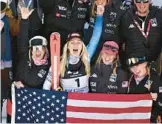  ?? JEFF PACHOUD/AFP ?? Mikaela Shiffrin, center, celebrates with teammates on the podium at the FIS Alpine Ski World Championsh­ip on Saturday in Meribel, French Alps.