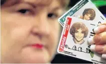  ?? BROWARD SHERIFF’S OFFICE /COURTESY ?? Broward Sheriff’s Office investigat­or Rusty McCormick holds two stolen ID cards.