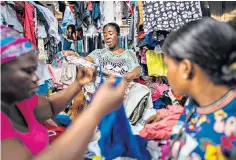  ?? ?? A tangle of discarded clothes on the beach in Jamestown, above. Joyce Osei Bonsu, left, sells secondhand dresses at the market but may have to quit