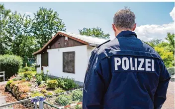  ?? FOTO: GUIDO KIRCHNER/DPA ?? Ein Polizeibea­mter steht vor einer inzwischen abgerissen­en Gartenlaub­e in einem Münsterane­r Stadtteil. Dort soll der Hauptangek­lagte im April mit drei weiteren Männern zwei Jungen sexuell missbrauch­t haben.