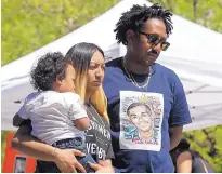  ?? RICH PEDRONCELL­I/ ASSOCIATED PRESS ?? Salena Manni, the fiancee of police shooting victim Stephon Clark, holds the couple’s son Aiden as she and Clark’s uncle, Curtis Gordon attend a rally Saturday in Sacramento, Calif.