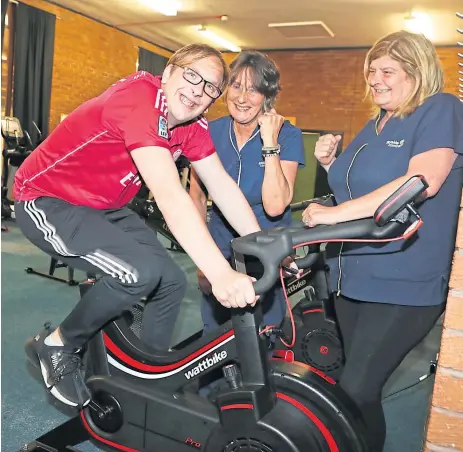  ??  ?? Michael Cook, 29, tries out a cycle cheered on by convener Fiona Cook (right) and vice convener Anne Pannell.