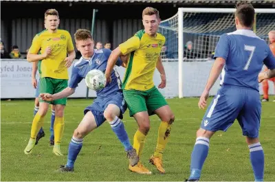  ?? Pic: DAI SINCLAIR ?? Caernarfon Town striker Cory Williams (yellow shirt) was a hero for the visitors at Llangefni