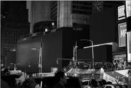  ?? ASSOCIATED PRESS ?? SCREENS IN TIMES SQUARE are black during a widespread power outage Saturday in New York. Authoritie­s say a transforme­r fire caused a power outage in Manhattan and left businesses without electricit­y, elevators stuck and subway cars stalled.