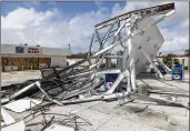  ?? BEACH POST LANNIS WATERS / THE PALM ?? A Mobil gas station on US 41 in Naples shows damage from Hurricane Irma on Monday.