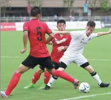  ?? GAO ERQIANG / CHINA DAILY ?? A player from the Portland-based Timbers team tries to fend off rivals from a middle school affiliated to Shanghai Tongji University during a 2017 tournament in Shanghai, where both grassroots and profession­al soccer is flourishin­g.