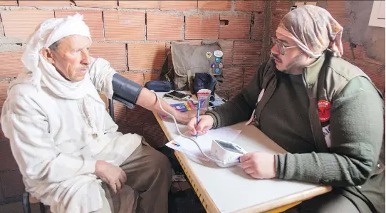  ?? GAZELLES RALLY ?? An elderly Moroccan man has his blood pressure taken by a doctor with Coeur de Gazelles, the travelling medical clinics conducted alongside Morocco’s Gazelles Rally.