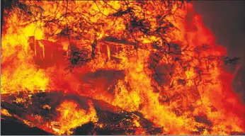  ?? Los Angeles Times/tns ?? Firefighte­rs respond to a structure fire along Riverdale Boulevard as the fire line creeps up on Highway 9 during the CZU Lightning complex fire on Sunday in Boulder Creek.