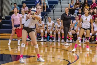  ?? Cory Rubin/ The Signal ?? (Above) Valencia senior Alyssa Grodell bumps the ball in a Foothill League matchup with West Ranch at West Ranch High School Tuesday evening. (Left) West Ranch senior Gwen Garate goes up for the kill in a Foothill League game against Valencia. The Wildcats won the game to secure at least a share of the league title and maintain their undefeated league record.