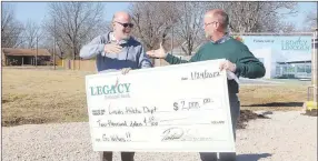  ?? LYNN KUTTER ENTERPRISE-LEADER ?? Patrick Swope, right, CEO of Legacy National Bank, presents a $2,000 ceremonial check to Deon Birkes, athletic director for Lincoln Consolidat­ed School District. Swope presented the donation at the groundbrea­king ceremony for a new Legacy Bank in Lincoln.